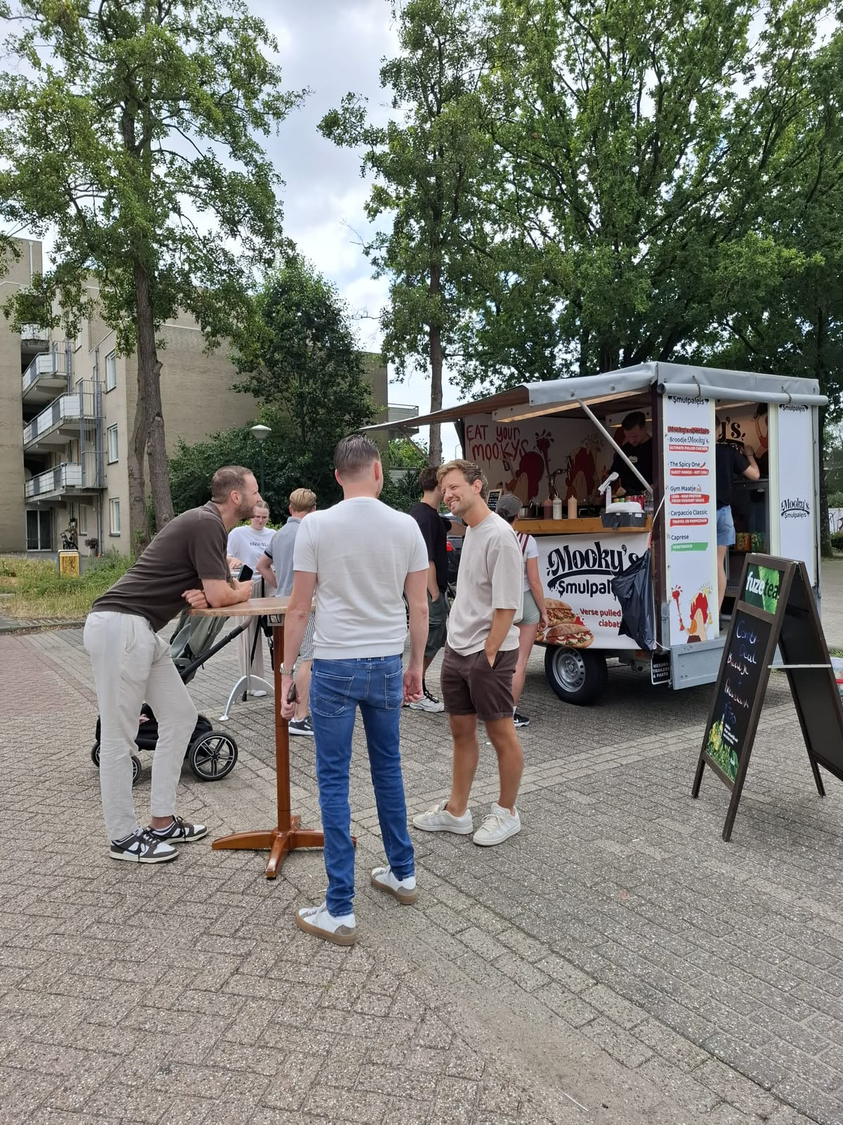Gasten genieten van hun Mooky's bij de truck